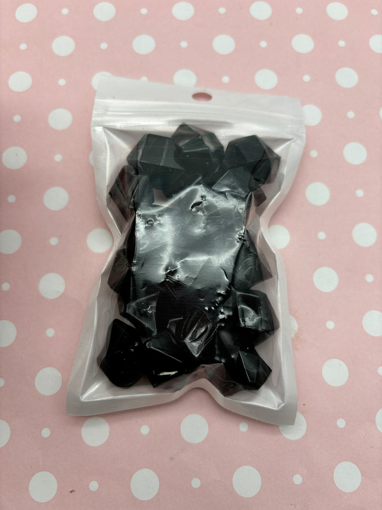 a package of black bows sitting on top of a table