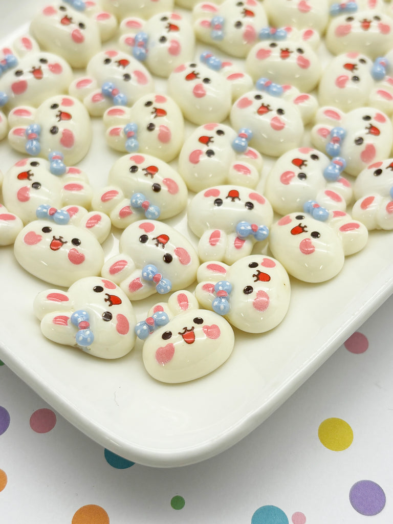 a white plate topped with lots of white and pink peepies
