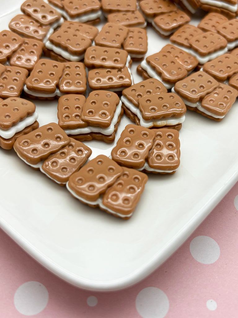 a white plate topped with lots of chocolate covered cookies