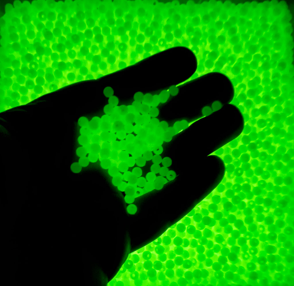 a person's hand is holding a green substance