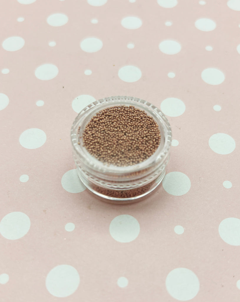 a small jar of glitter sitting on top of a polka dot tablecloth