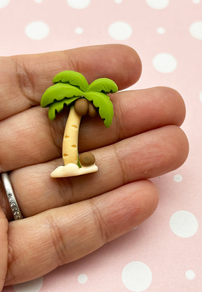a person holding a small toy palm tree