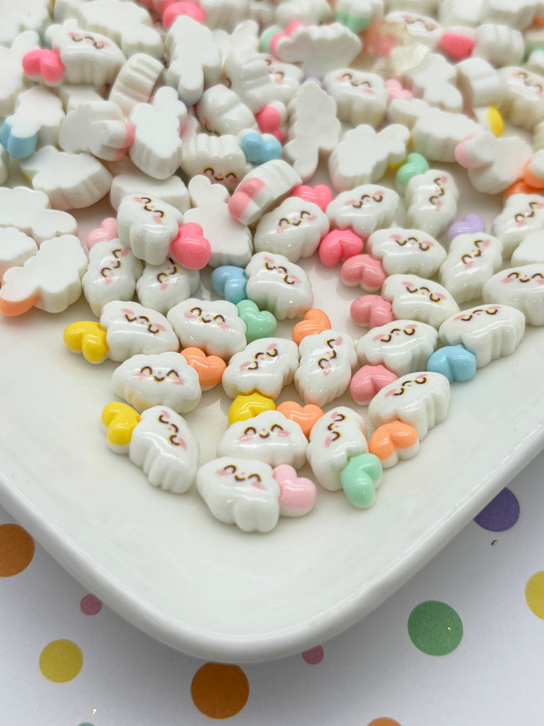 a white plate topped with marshmallows on top of a polka dot table