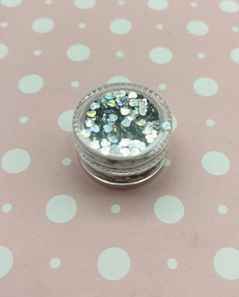 a close up of a glass container on a polka dot table cloth