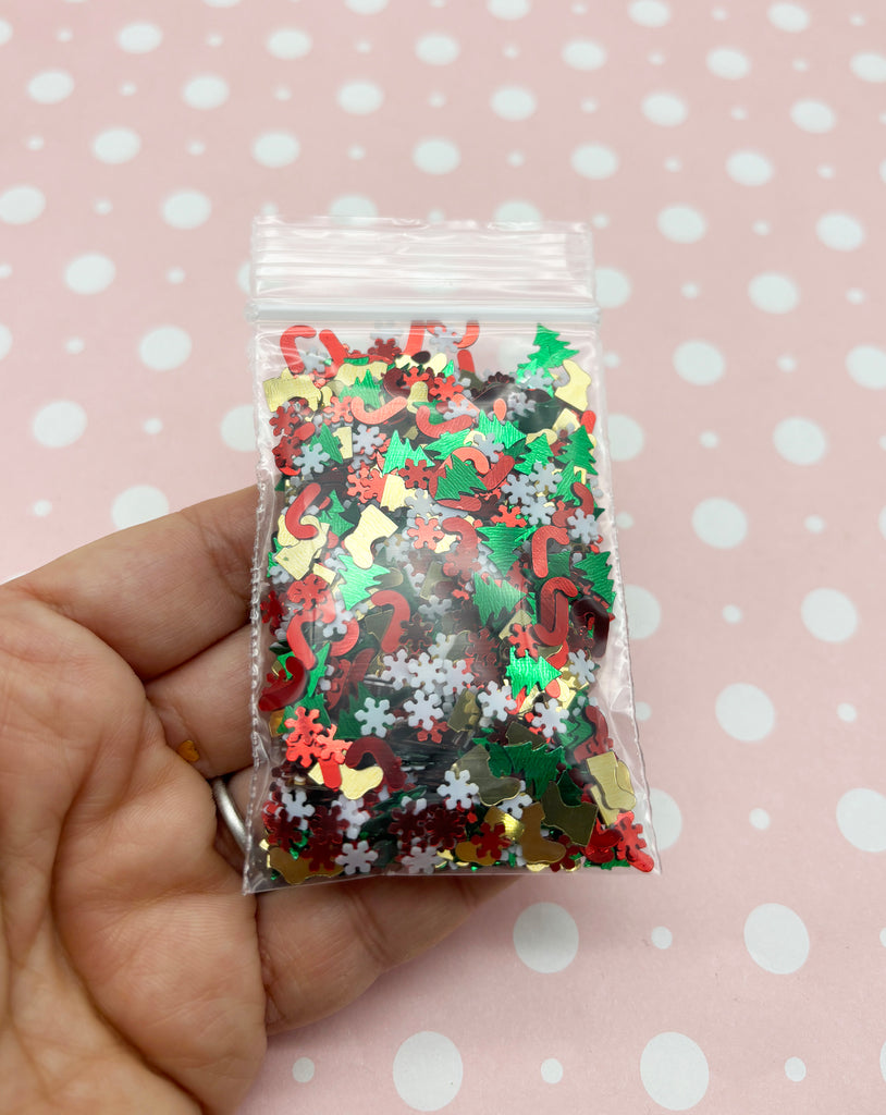 a hand holding a bag of christmas confetti