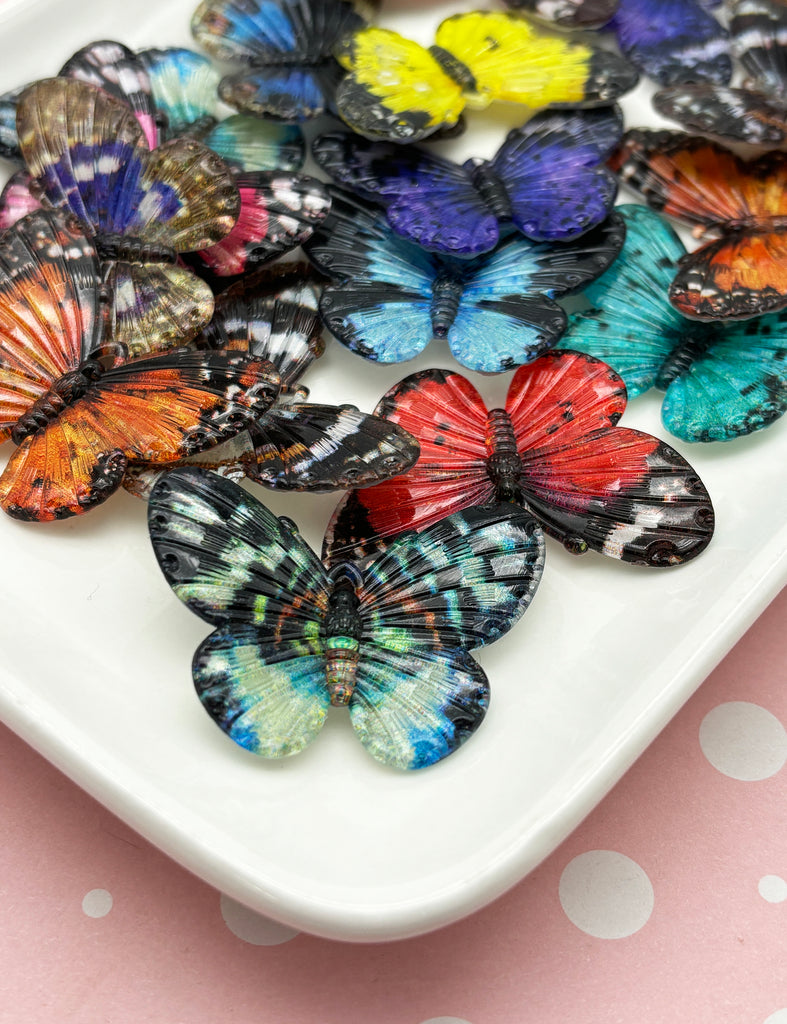 a white plate topped with lots of colorful butterflies