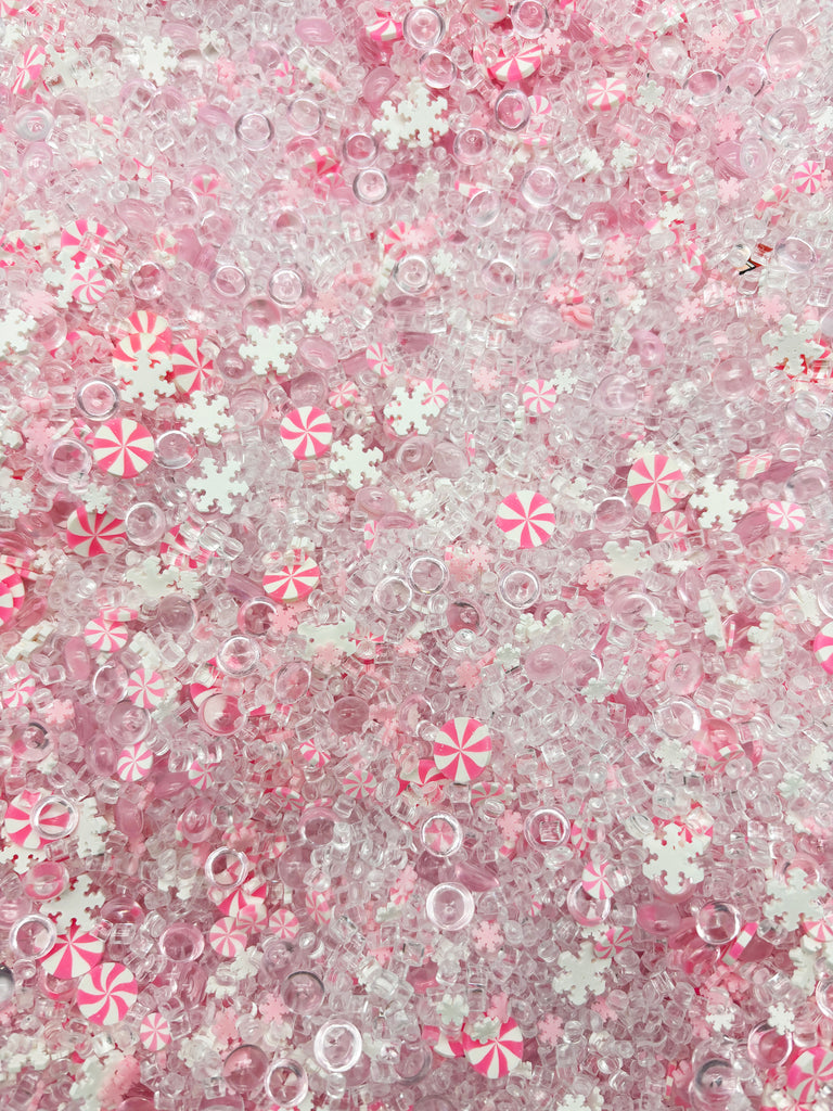 a pink and white background with candy canes and snowflakes